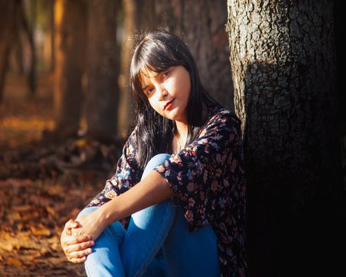 Woman meditating outdoors in nature sunlight